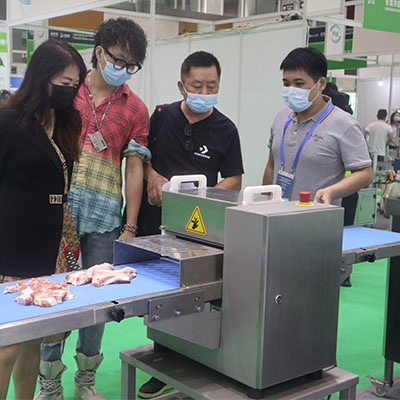 Display of advanced fruit processing machines used for peeling, slicing, and juicing at the trade show.